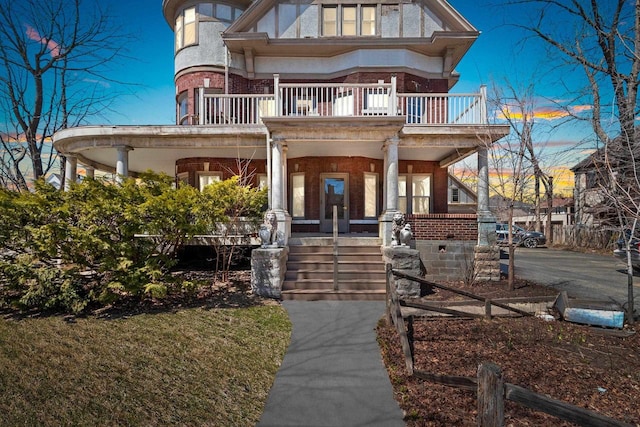 303 N Ashland Ave, Green Bay, WI 54303 - victorian home featuring brick siding, a porch, and a balcony