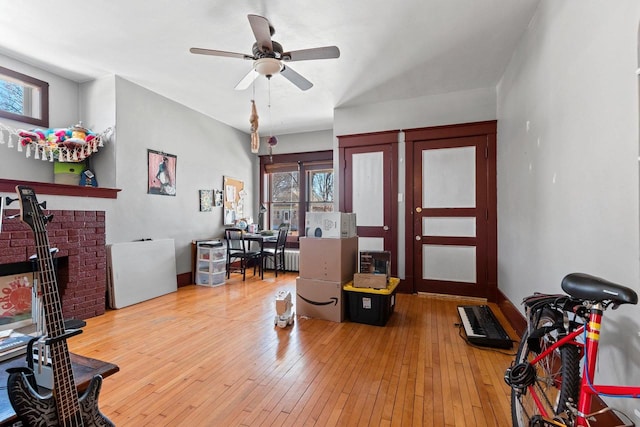303 N Ashland Ave, Green Bay, WI 54303 - interior space featuring a fireplace, a ceiling fan, and hardwood / wood-style flooring