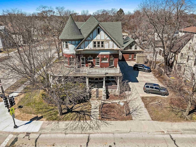 303 N Ashland Ave, Green Bay, WI 54303 - view of front of house featuring brick siding, roof with shingles, and a porch
