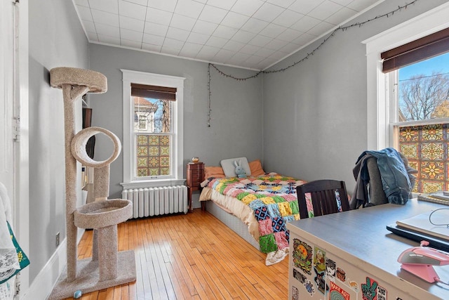 303 N Ashland Ave, Green Bay, WI 54303 - bedroom featuring radiator heating unit and light wood finished floors
