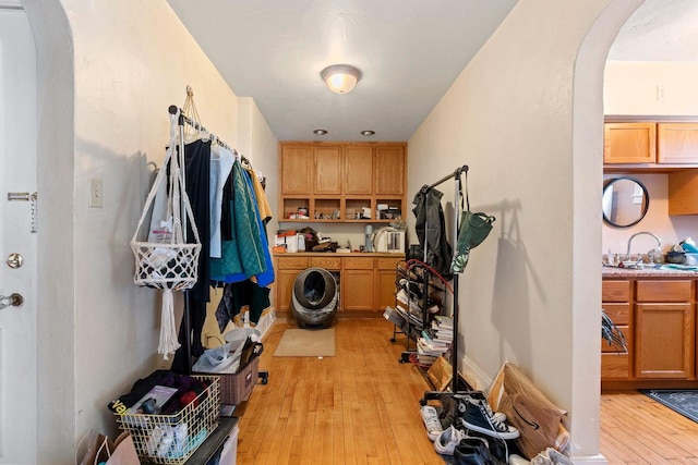 303 N Ashland Ave, Green Bay, WI 54303 - interior space featuring a sink, arched walkways, and light wood-style floors