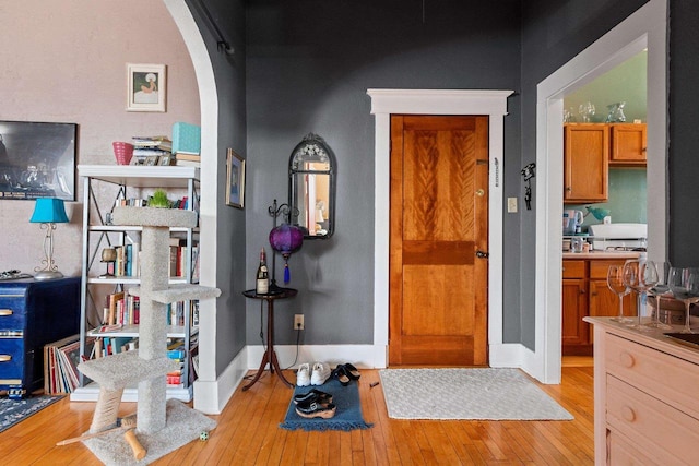 303 N Ashland Ave, Green Bay, WI 54303 - foyer entrance featuring light wood-style flooring, baseboards, and arched walkways