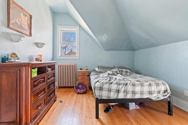 303 N Ashland Ave, Green Bay, WI 54303 - bedroom featuring lofted ceiling, light wood-style floors, and radiator