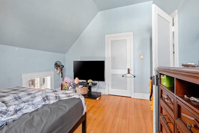 303 N Ashland Ave, Green Bay, WI 54303 - bedroom with vaulted ceiling and light wood-style flooring