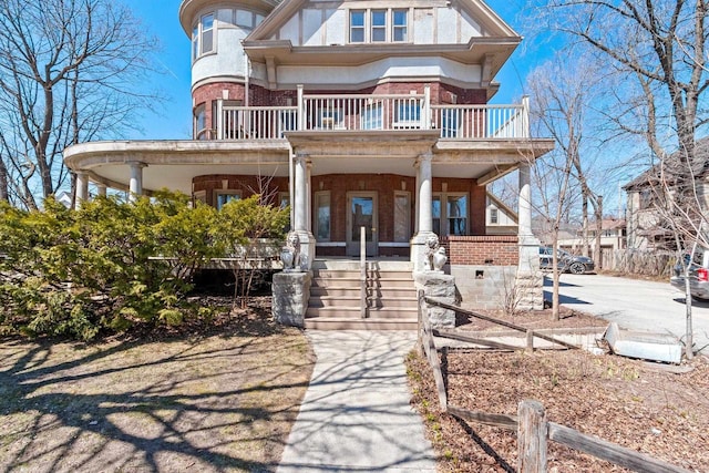 303 N Ashland Ave, Green Bay, WI 54303 - victorian-style house with brick siding, a balcony, and covered porch