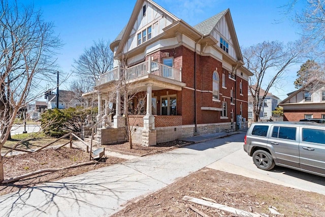 303 N Ashland Ave, Green Bay, WI 54303 - exterior space featuring a porch, a balcony, and brick siding