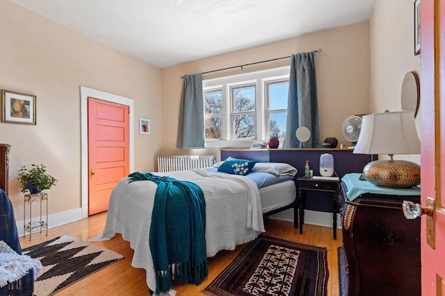 303 N Ashland Ave, Green Bay, WI 54303 - bedroom featuring radiator and light wood-style floors