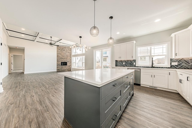 kitchen with stainless steel dishwasher, white cabinetry, gray cabinets, and tasteful backsplash