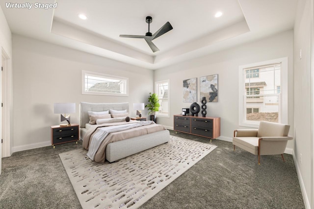 bedroom featuring a raised ceiling, baseboards, recessed lighting, and carpet floors