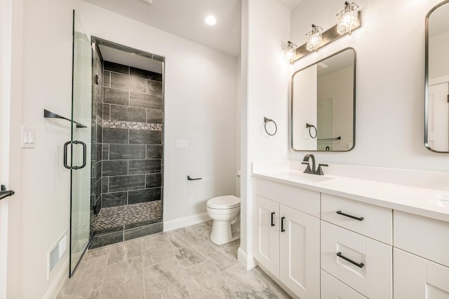 bathroom featuring visible vents, a shower stall, a sink, baseboards, and toilet