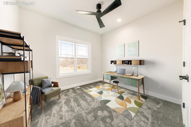 office space with a ceiling fan, baseboards, and carpet
