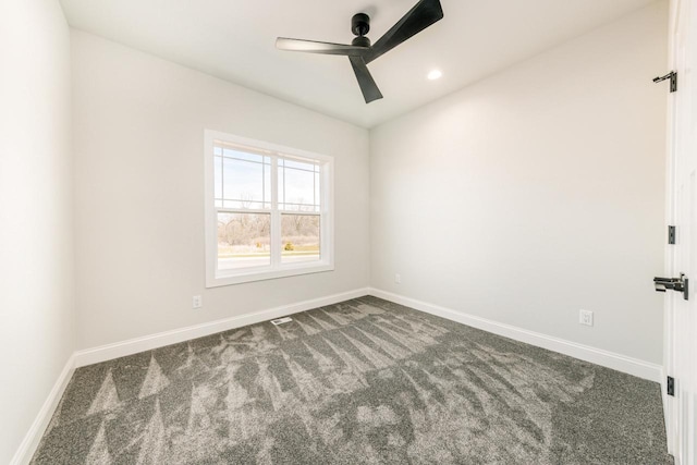 spare room featuring carpet floors, baseboards, and ceiling fan