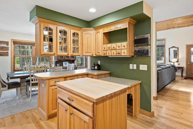 bar featuring light wood-style floors, a wealth of natural light, and baseboards