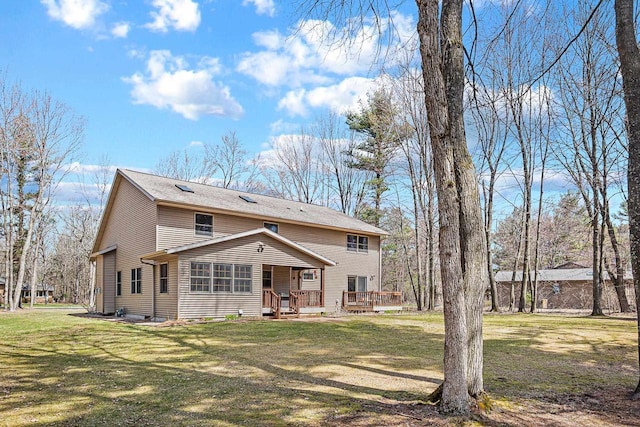 back of property featuring a yard and a deck