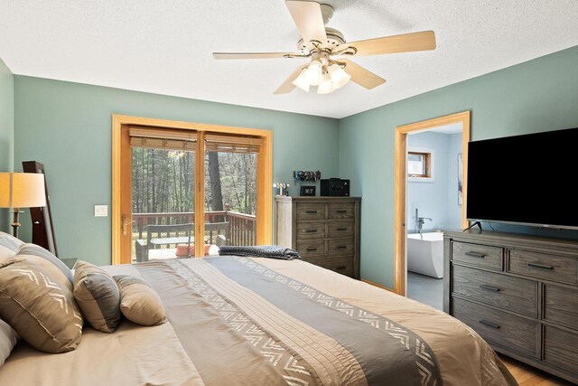 bedroom featuring access to outside, ceiling fan, and connected bathroom