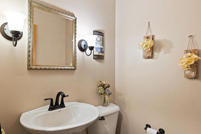 bathroom featuring toilet and a sink