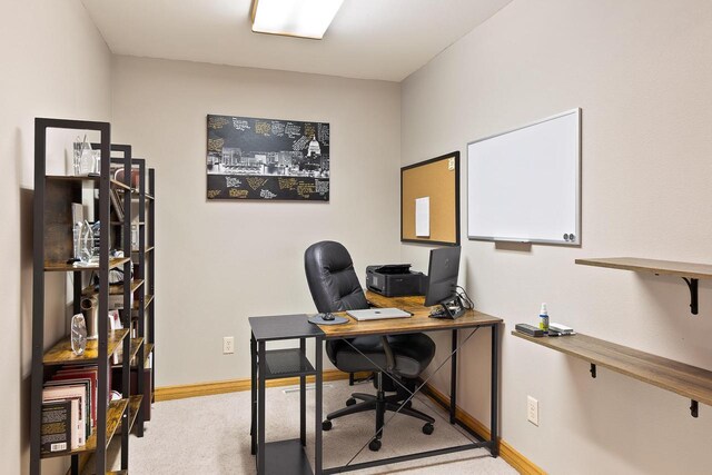 office space featuring baseboards and carpet