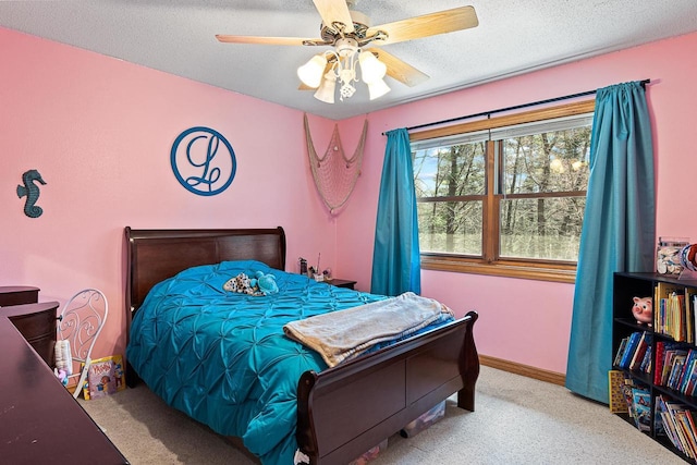 bedroom with carpet floors, a textured ceiling, and a ceiling fan