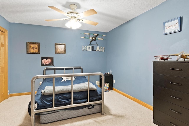 bedroom featuring baseboards, a ceiling fan, and carpet flooring