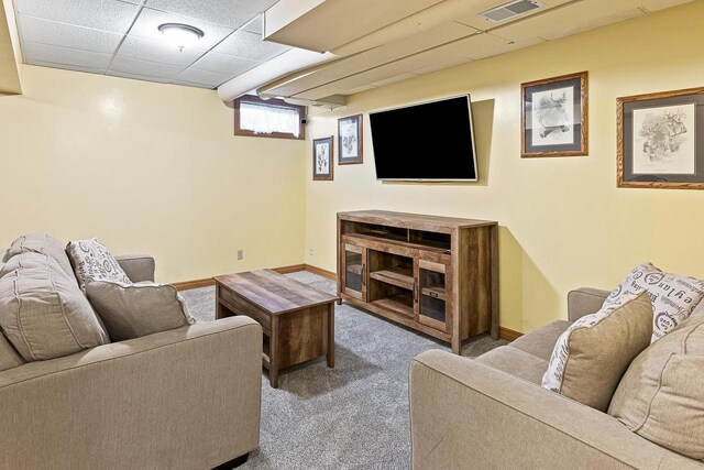 living area featuring visible vents, carpet flooring, baseboards, and a drop ceiling