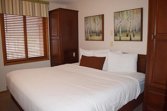 carpeted bedroom with baseboards
