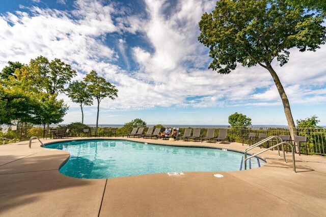 pool with fence and a patio area