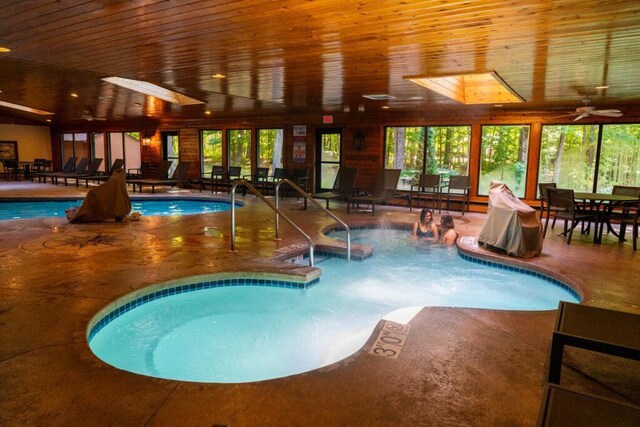 pool featuring ceiling fan, outdoor dining area, and a patio area