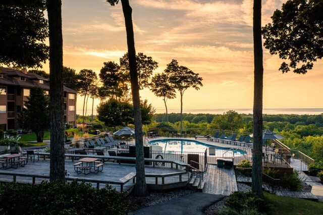 dock area with a community pool and fence