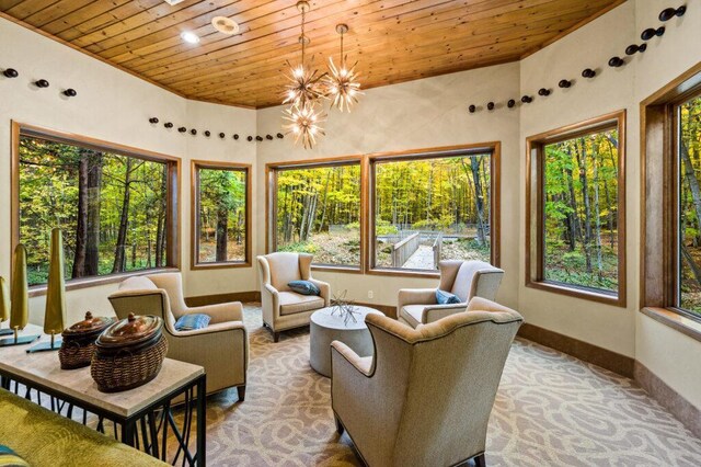 sunroom / solarium featuring a chandelier and a wealth of natural light