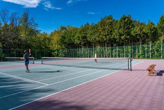 view of sport court featuring community basketball court and fence