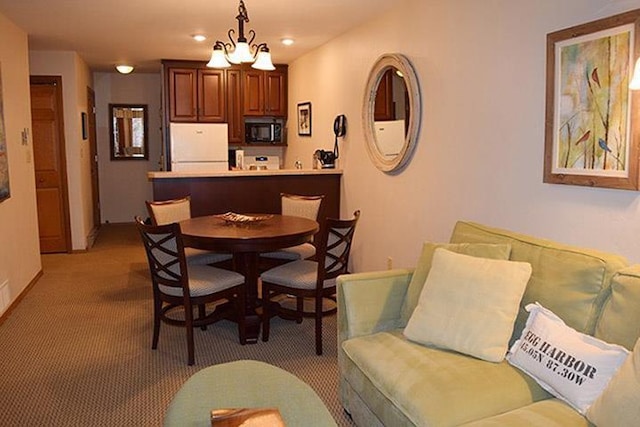 dining area with recessed lighting, baseboards, and light carpet