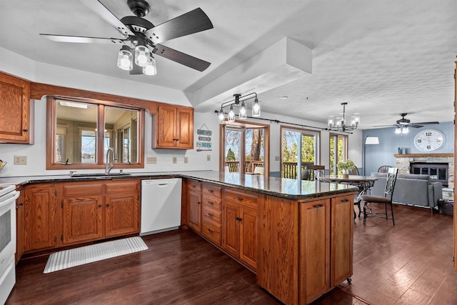 1096 Lakeshore Dr, Menasha, WI 54952 - kitchen featuring a peninsula, a sink, ceiling fan with notable chandelier, white appliances, and brown cabinets