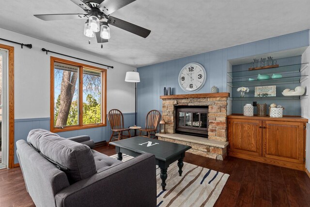 1096 Lakeshore Dr, Menasha, WI 54952 - living room featuring wainscoting, a stone fireplace, ceiling fan, and dark wood finished floors
