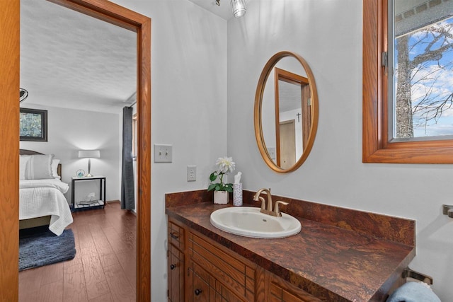 1096 Lakeshore Dr, Menasha, WI 54952 - ensuite bathroom featuring wood finished floors, a textured ceiling, vanity, and ensuite bathroom