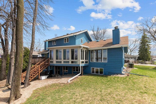 1096 Lakeshore Dr, Menasha, WI 54952 - rear view of house featuring a chimney, stairs, a deck, a yard, and a sunroom