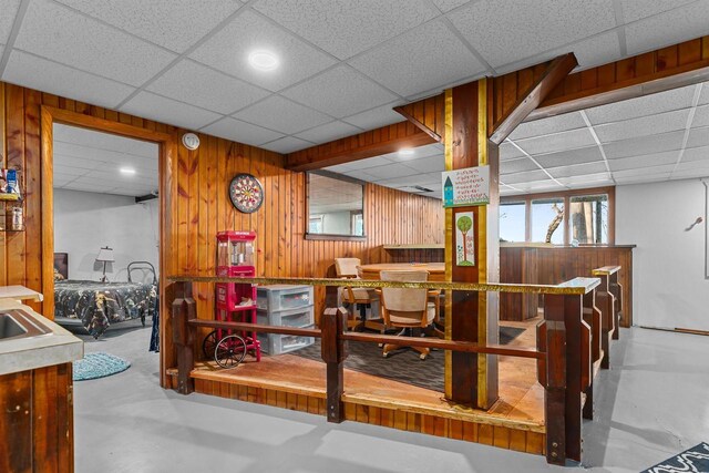 1096 Lakeshore Dr, Menasha, WI 54952 - dining room with concrete floors, wooden walls, and a drop ceiling