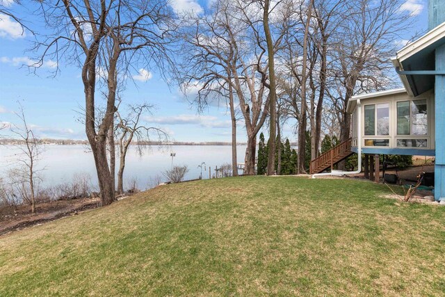 1096 Lakeshore Dr, Menasha, WI 54952 - view of yard with a sunroom, a water view, and stairs