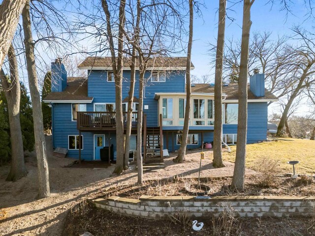 1096 Lakeshore Dr, Menasha, WI 54952 - back of property featuring a chimney, a deck, stairs, and a shingled roof