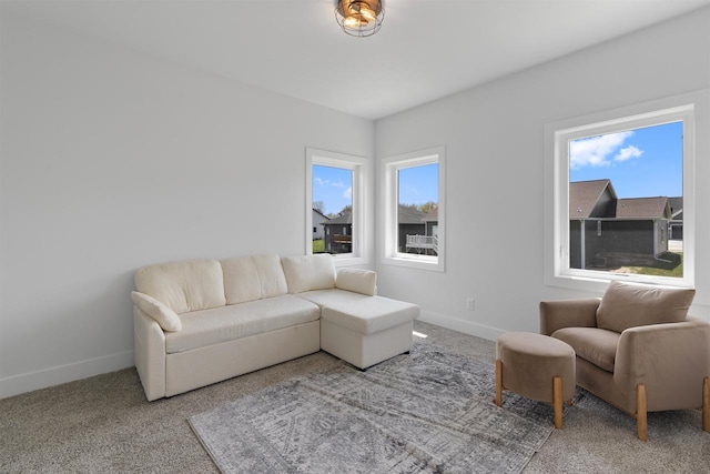 living room with baseboards and carpet flooring