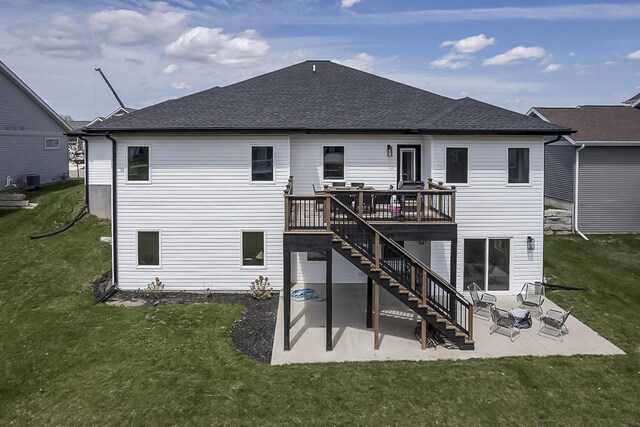 back of house with stairs, a patio area, a yard, and a deck