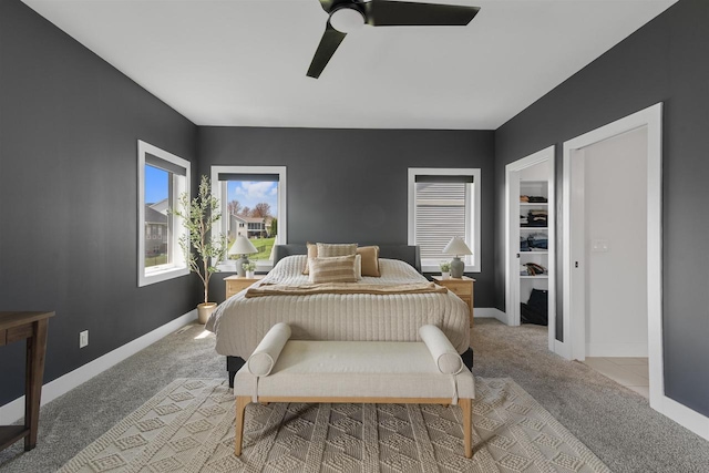 carpeted bedroom featuring ceiling fan and baseboards