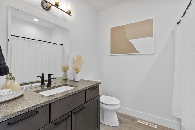 full bathroom with visible vents, wood finished floors, vanity, baseboards, and toilet