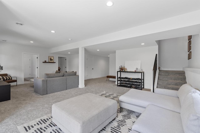 living room with stairway, recessed lighting, and light colored carpet