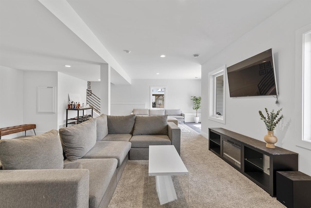 living area with recessed lighting, carpet flooring, and stairway