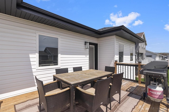 wooden deck with grilling area and outdoor dining area