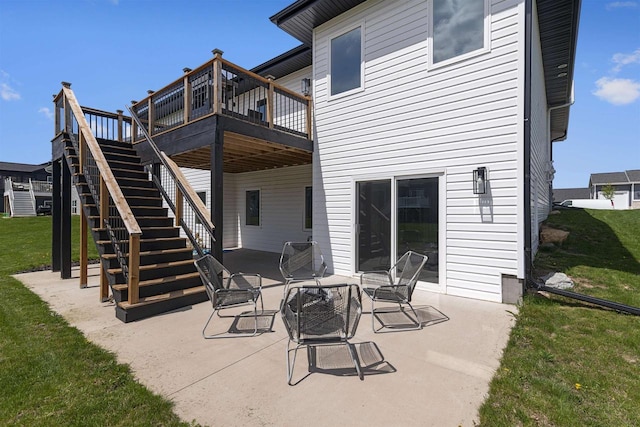 rear view of property featuring a wooden deck, a patio, and a yard