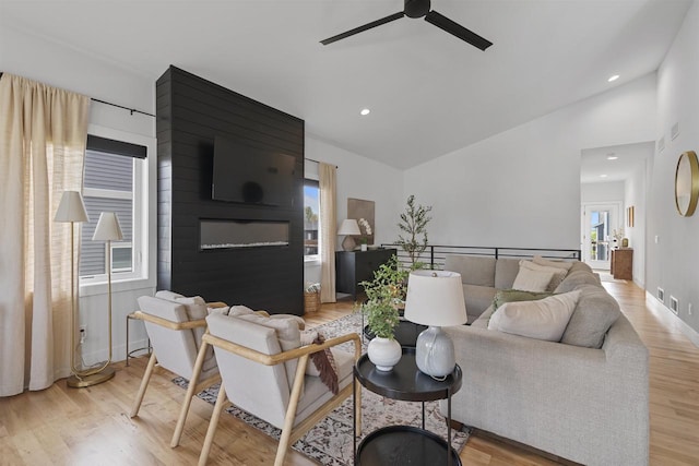 living room with a ceiling fan, high vaulted ceiling, recessed lighting, and wood finished floors