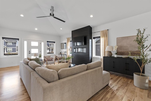 living area featuring recessed lighting, a ceiling fan, light wood-style flooring, and lofted ceiling