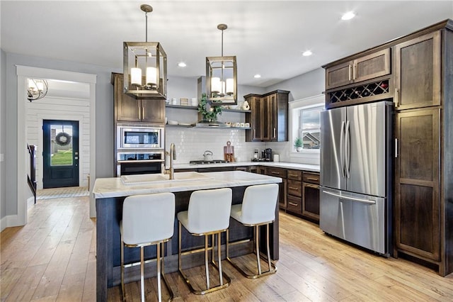 3426 Creek Ridge Dr, Eau Claire, WI 54703 - kitchen with plenty of natural light, open shelves, light countertops, dark brown cabinetry, and appliances with stainless steel finishes