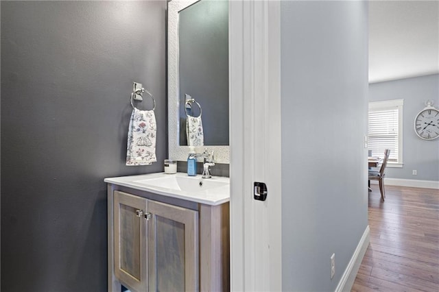 3426 Creek Ridge Dr, Eau Claire, WI 54703 - bathroom with wood finished floors, baseboards, and vanity